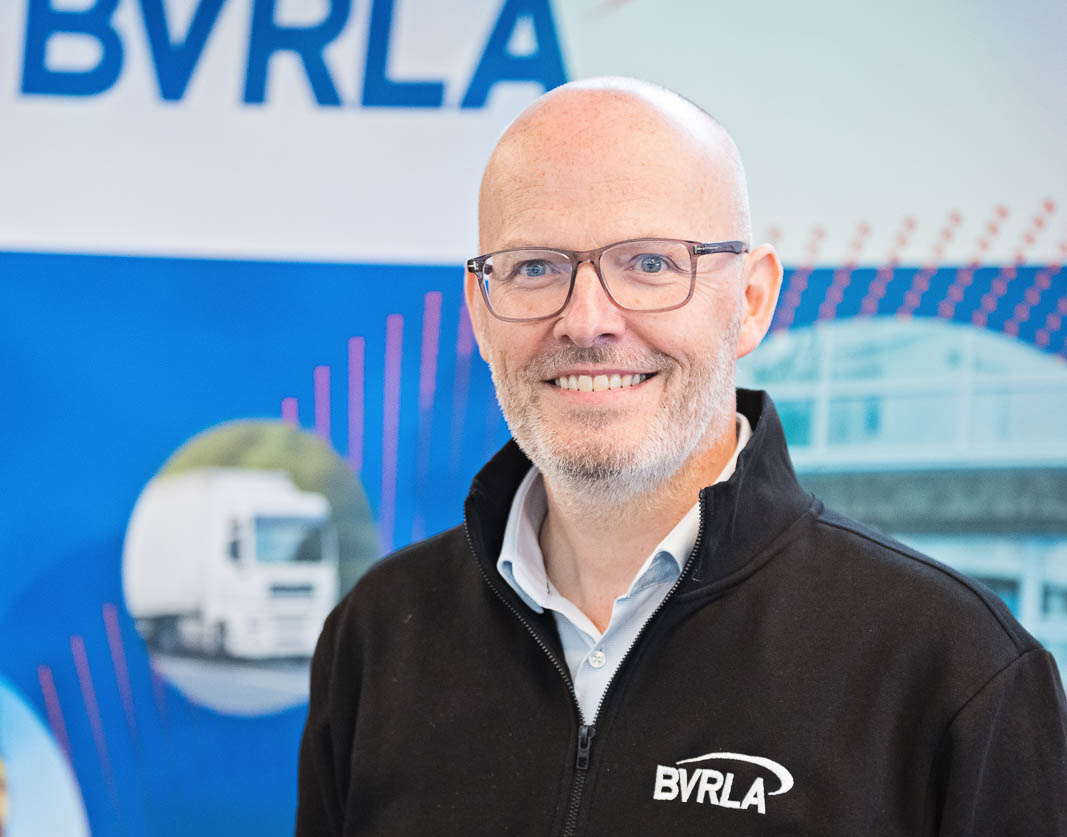 Toby Poston, BVRLA Chief Executive standing in front of a BVRLA event banner